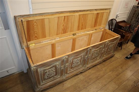 A French provincial chest, the front carved with three foliate panels, W.240cm, D.62cm, H.78cm